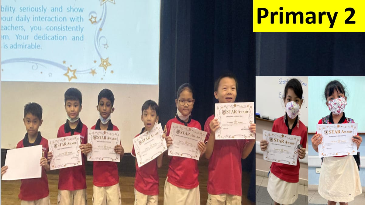 Eight Primary 2 students in red uniforms hold Star Award certificates in front of a projection screen.